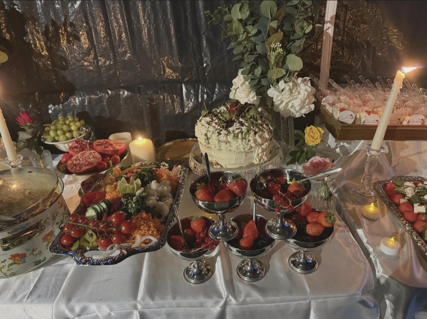 An abundant Roseberry spread of fruit, salads, cake and candlelight